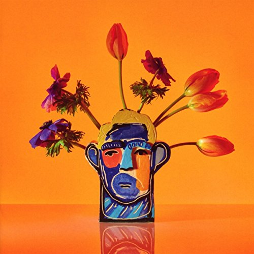 The image depicts a stylized illustration of a man's head and shoulders, rendered in a vibrant color palette. The man is shown wearing sunglasses and a sweater, with a subtle reflection visible below him. The background features a gradient that transitions from yellow at the top to orange towards the bottom. Alt text: "Illustration of a man's head wearing sunglasses on an orange background."