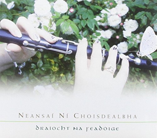 "Woman's hands holding a flute, surrounded by white flowers and a butterfly."