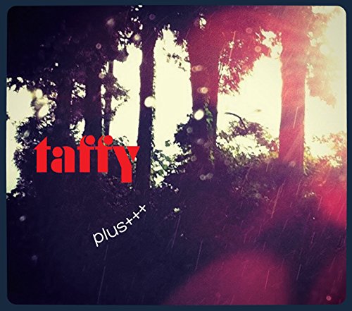 The image is a CD cover for "Taffy - Plus+++". The alt text is: "CD cover with forest scene, rain, and red text."