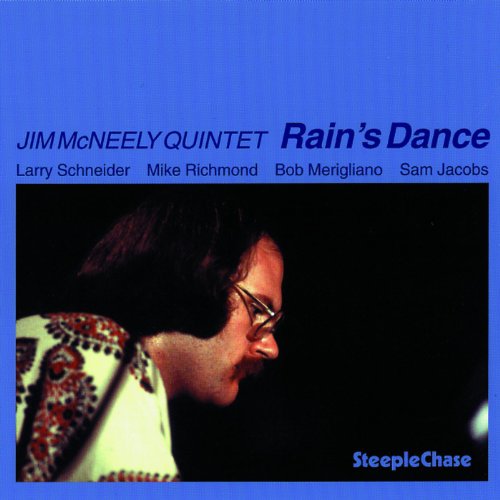 "Album cover with a man in profile against a blue background, wearing patterned shirt."