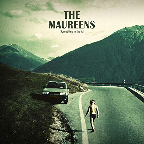 Vinyl album cover with a man walking down a mountain road.