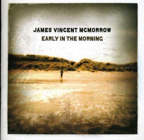 "Album cover with a person standing alone on a sandy beach, sepia-toned image."