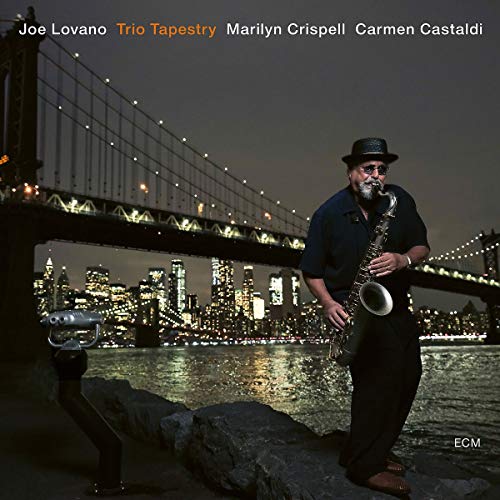 "Album cover featuring a man playing saxophone by a lit city bridge at night."