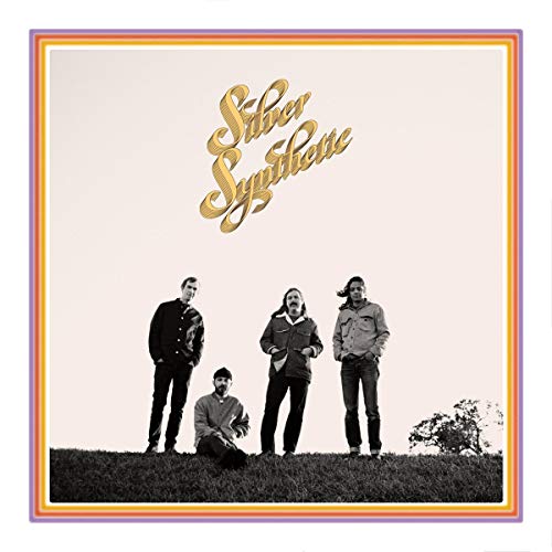 Album cover with four men standing on grass, surrounded by multicolored border.