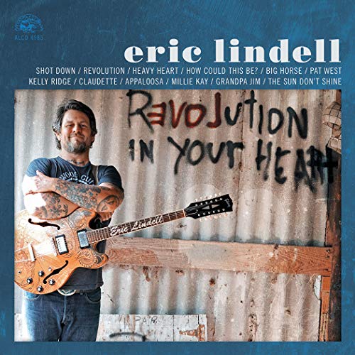 Orange vinyl record with blue album cover featuring a man holding a guitar.