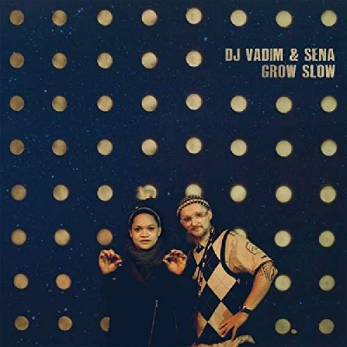 Vinyl album cover featuring two people against a dark blue background with circular lights.