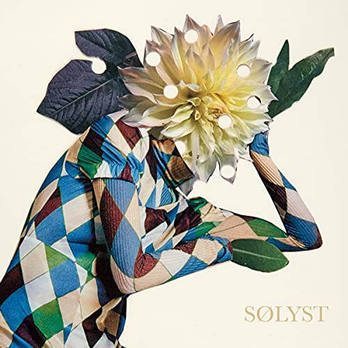 A person made of patchwork fabric with a large yellow flower for a head.