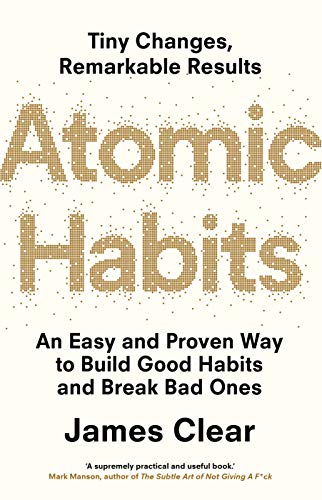 "Book cover of 'Atomic Habits' by James Clear, with gold dotted title on beige background."