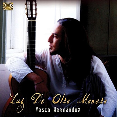"Man with long hair holding a guitar, album cover with text."