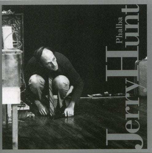 "Album cover with black and white image of man crouching, artist and title text."