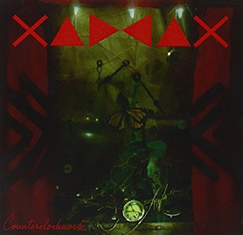 Dark album cover with red geometric shapes and a steampunk-inspired central figure.