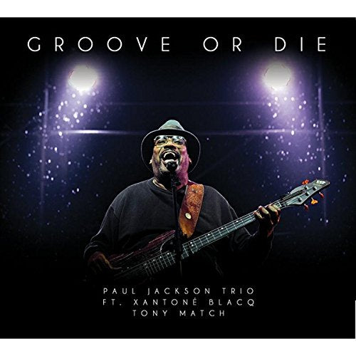 "Album cover with man playing guitar under spotlights, titled 'Groove or Die'."