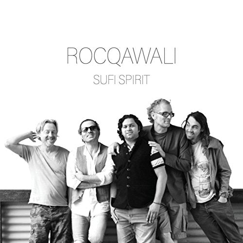 "Black and white image of five men standing together, posing for the camera."
