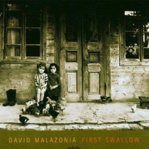 "CD cover featuring sepia-toned image of two children sitting with chickens outside a wooden house."