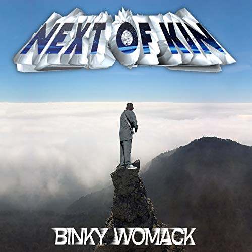 "Album cover featuring a man standing on a rocky peak with 'Next of Kin' text."