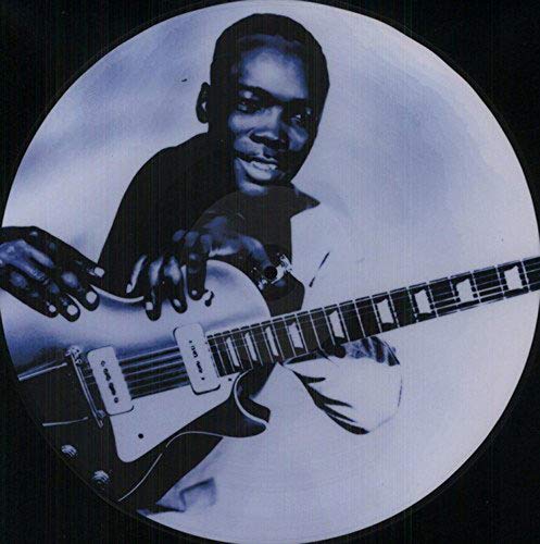 Black and white vinyl record with image of man holding electric guitar.