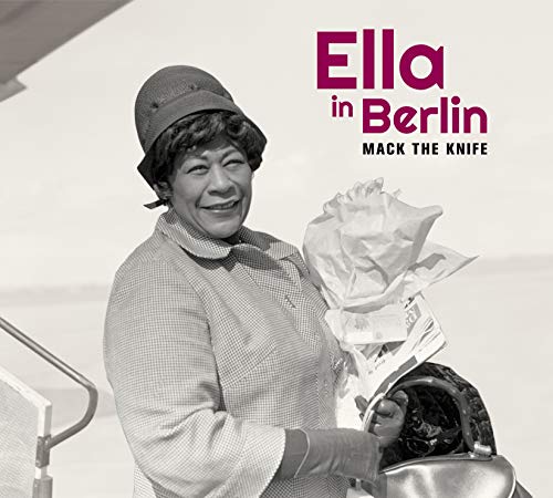 "Ella Fitzgerald holds roses and a purse, smiling, on a CD cover."