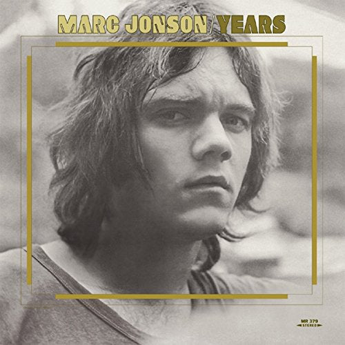 "Black and white album cover featuring a man with shoulder-length hair, surrounded by a gold border."