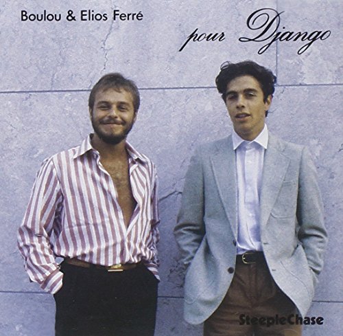 "Album cover featuring two men standing against a gray stone wall."