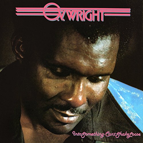 "CD album cover featuring a man with a serious expression, pink text and logo."