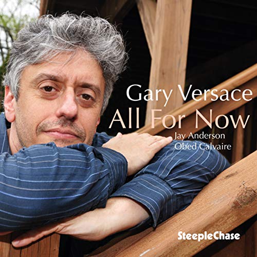 Album cover with a man leaning on a wooden railing, wearing a blue striped shirt.