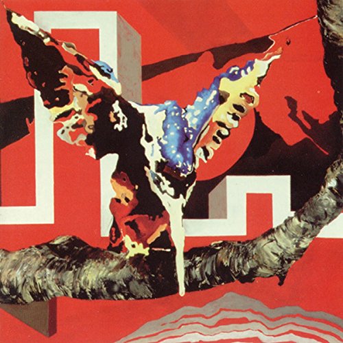The image is a red album cover with a bird-like figure. For accessibility purposes, a suitable alt text could be: "Red album cover with abstract bird-like figure in front of geometric shapes."