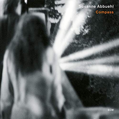 "CD cover with black and white image of a woman and light beams."
