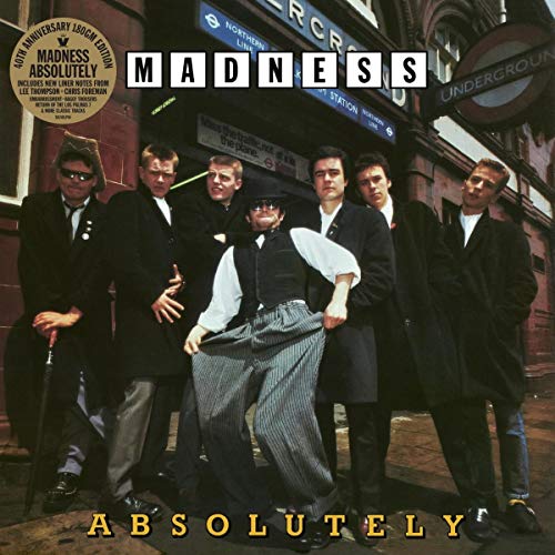 "Album cover featuring six men in suits standing outside a London Underground station."