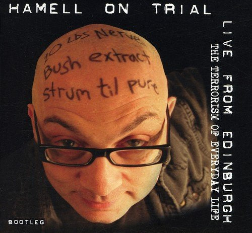 Album cover with a man with writing on his bald head and glasses.
