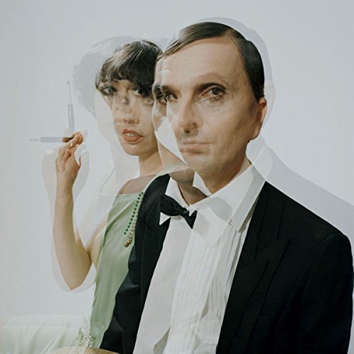 A man and woman in formal attire, double-exposed on a vinyl record cover.