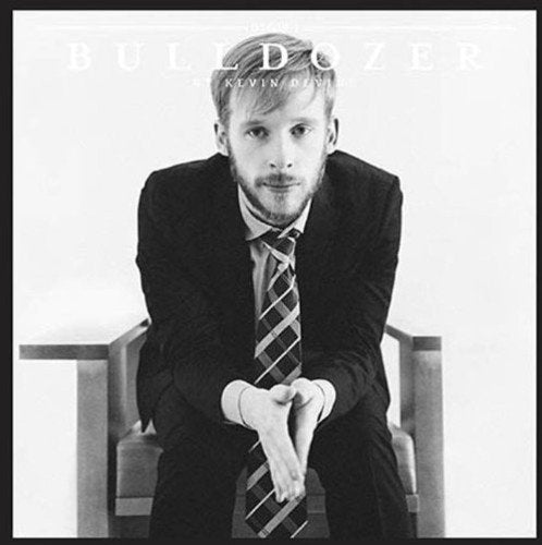 Black and white album cover with man in suit sitting on a chair.