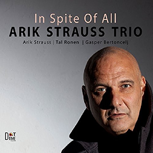 Arik Strauss' album cover featuring a close-up of his face against a grey background.