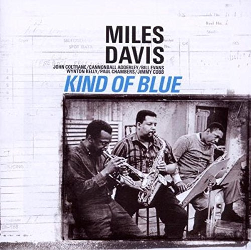 "Album cover with black and white image of three men playing instruments, titled 'Kind of Blue'."