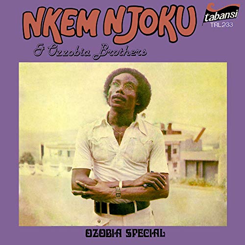 Purple album cover with a man standing in front of a building.