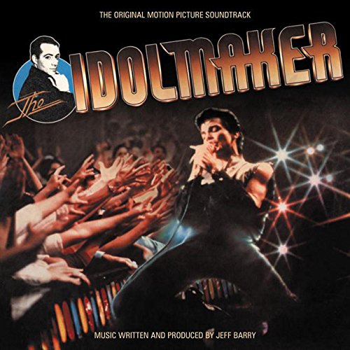 "Album cover featuring a man performing on stage with outstretched hands reaching towards him."