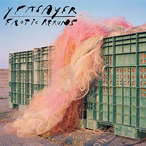 "Album cover with pink netting spilling from green crates on a gravel surface."