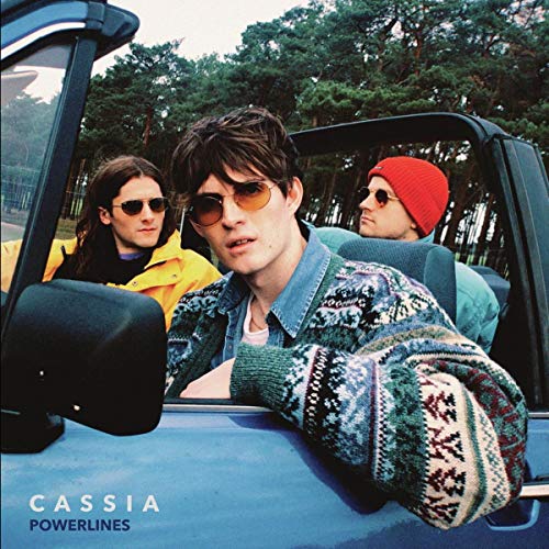 "Album cover featuring three people in a blue car, wearing sunglasses and casual clothing."