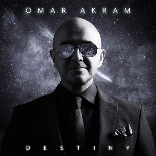Album cover with a bald man in a suit against a starry galaxy background.