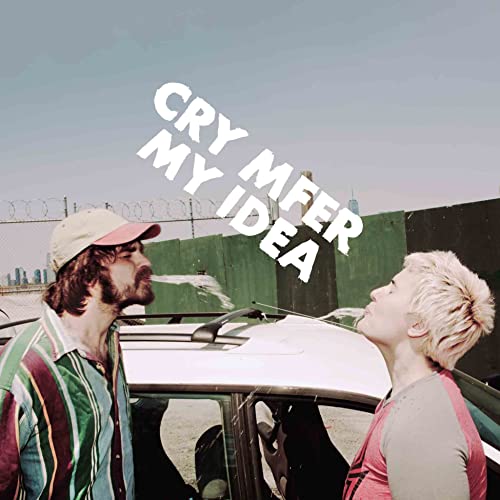 CD cover with two people looking up at a bright sky, fence behind.