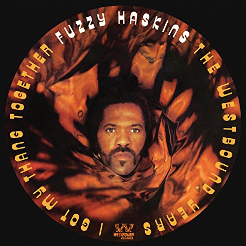 Album cover with man surrounded by fabric, text "Fuzzy Haskins" and "Westbound Years" on black background.