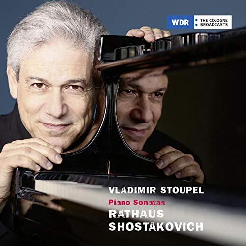 Man with gray hair playing piano, with reflection visible, on a CD cover.