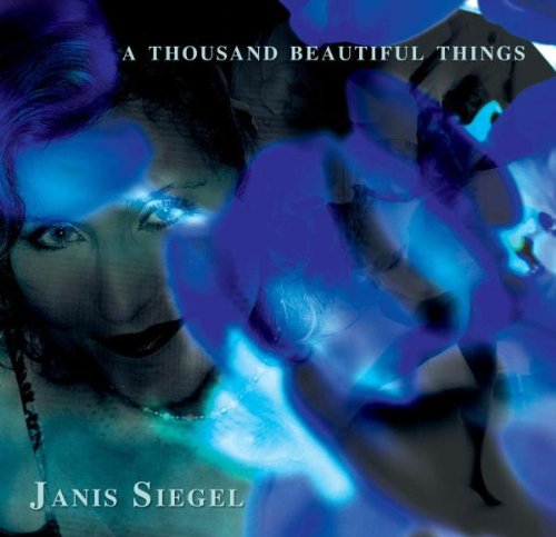 "CD cover with a woman's face and blue abstract shapes, titled 'A Thousand Beautiful Things'."