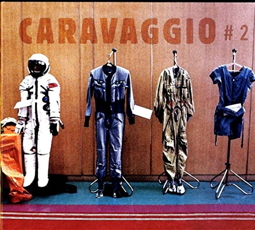 "Album cover featuring four mannequins in different outfits against a wooden wall."