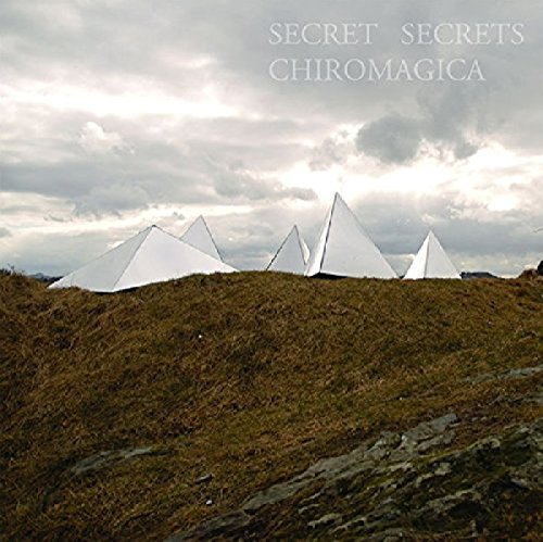 A vinyl record cover featuring white pyramids on a grassy hill under a cloudy sky.