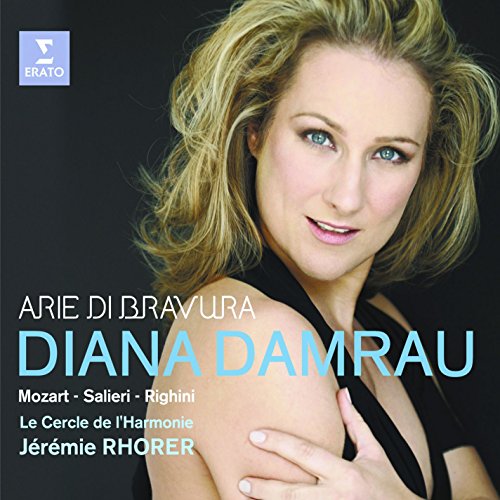"CD cover featuring a woman with blonde hair and a black dress against a dark background."
