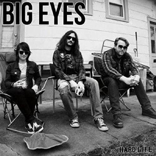 "Black and white album cover with three men sitting in lawn chairs outside a house."