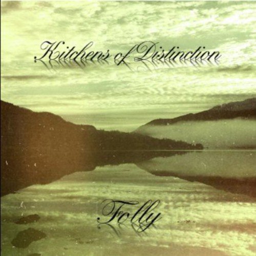 "Album cover with lake and mountains, 'Kitchens of Distinction' and 'Folly' in black script."