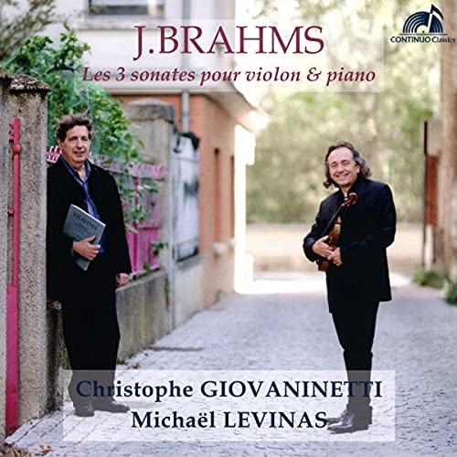 CD cover featuring two men, one holding a violin, standing on a cobblestone street.