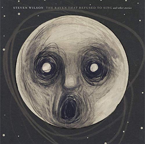 A drawn, white, ghostly face with large eyes and open mouth on a dark background.