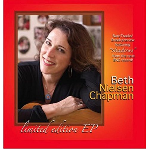Album cover with a smiling woman on a red and orange background.